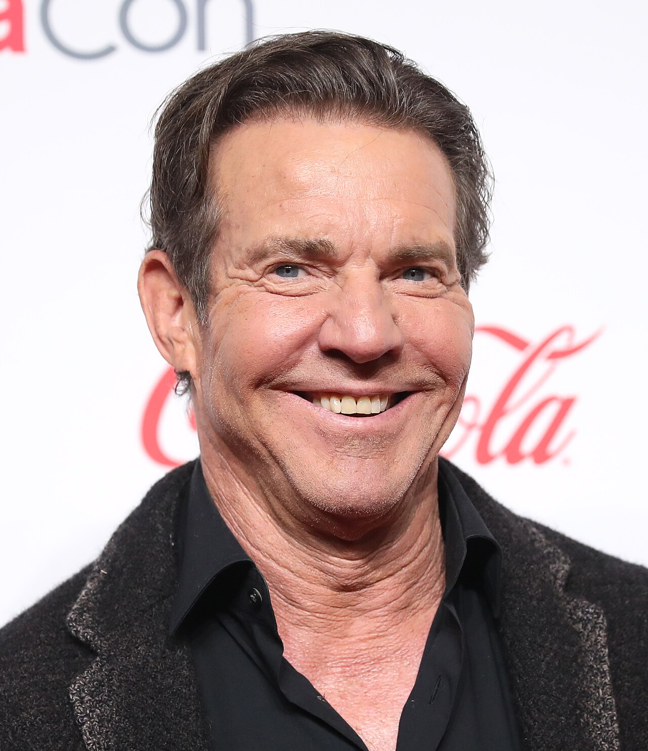 Dennis Quaid smiling at CinemaCon in 2024