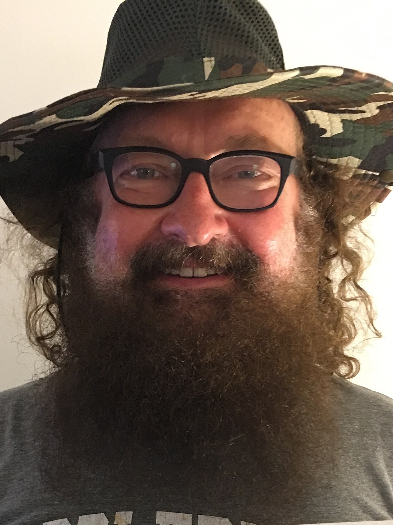 Randy Quaid wearing glasses and a wide-brimmed hat in 2017